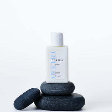 Lightweight Conditioner for all hair types balanced on rocks